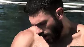 Bob Hager, a bearded hunk, masturbates in a pool on a sunny day